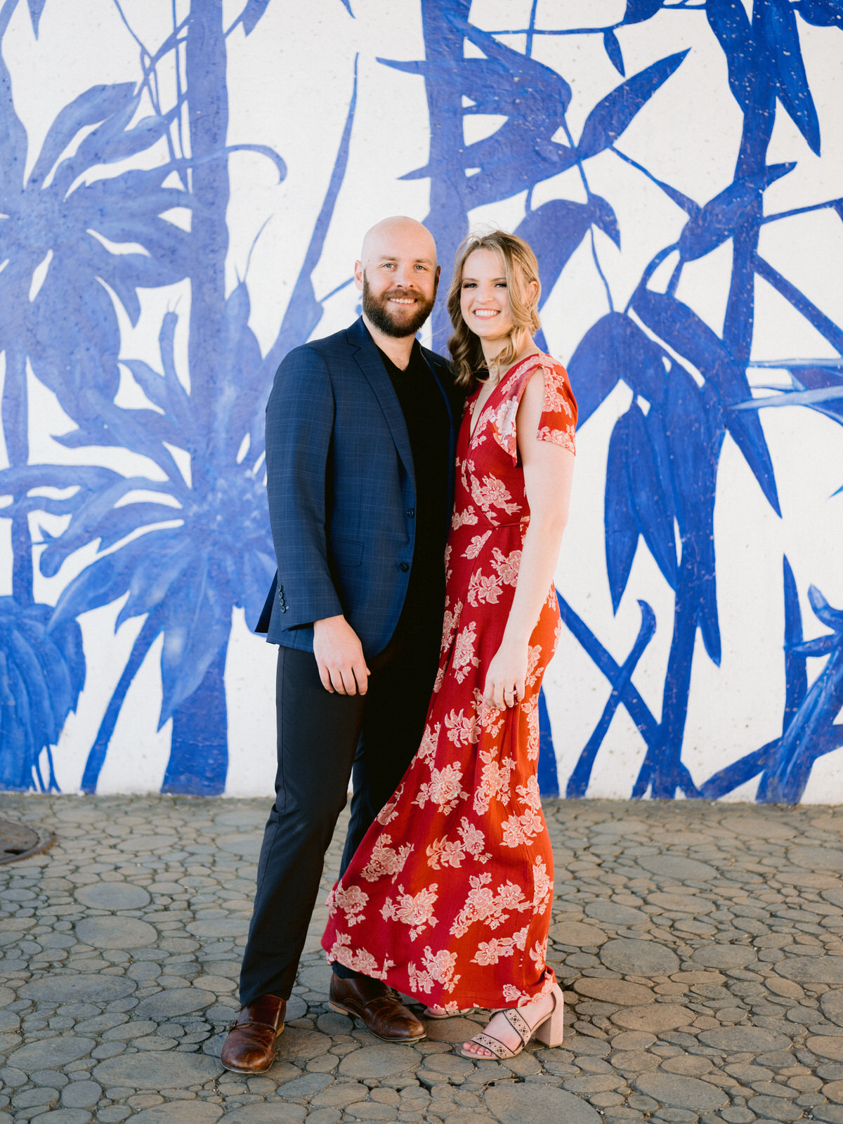 ping tom memorial park engagement photos in front of blue floral mural under the bridge