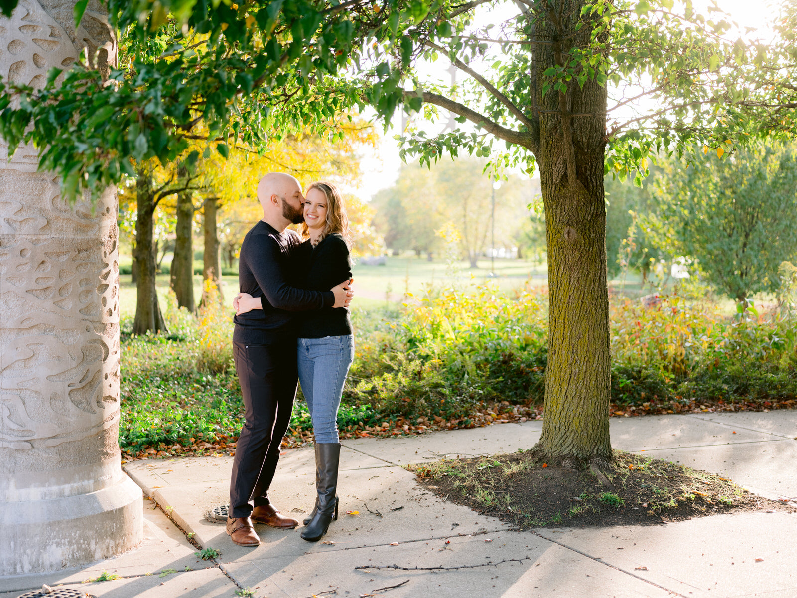 ping tom memorial park engagement photos couple smiling and kissing near tree