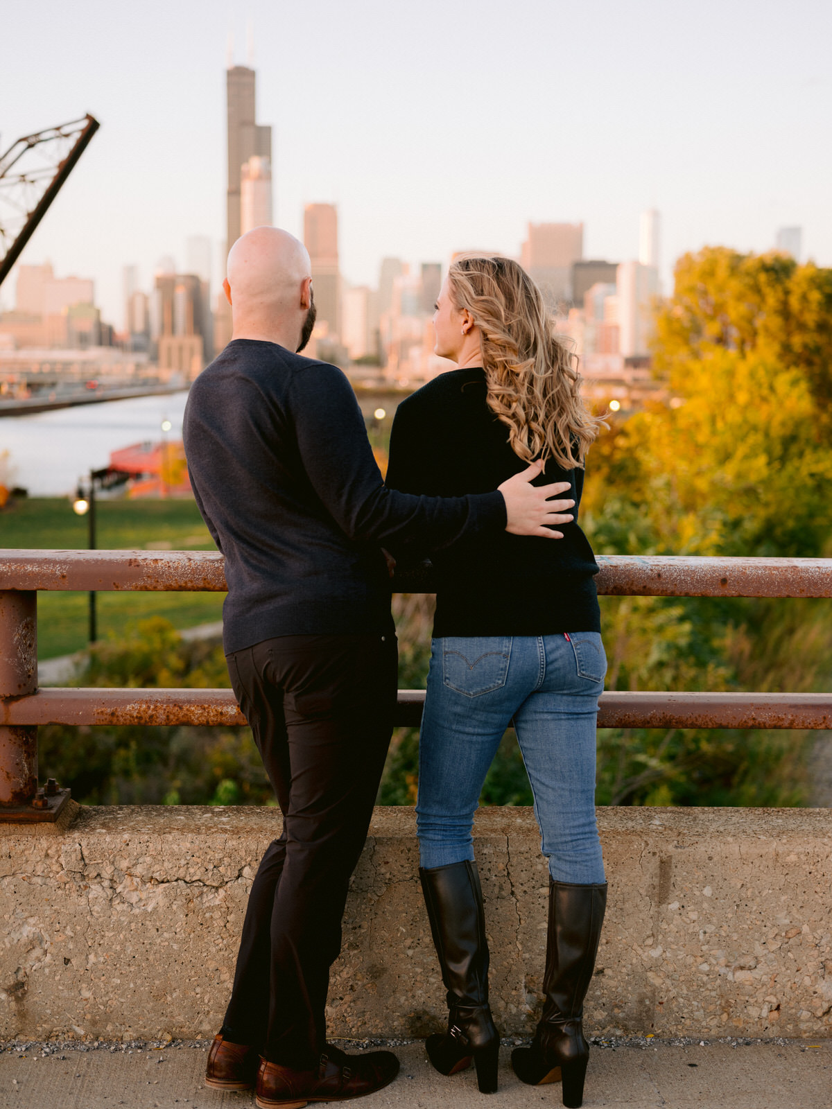 ping tom memorial park engagement photos couple looking over the Chicago river and skyline