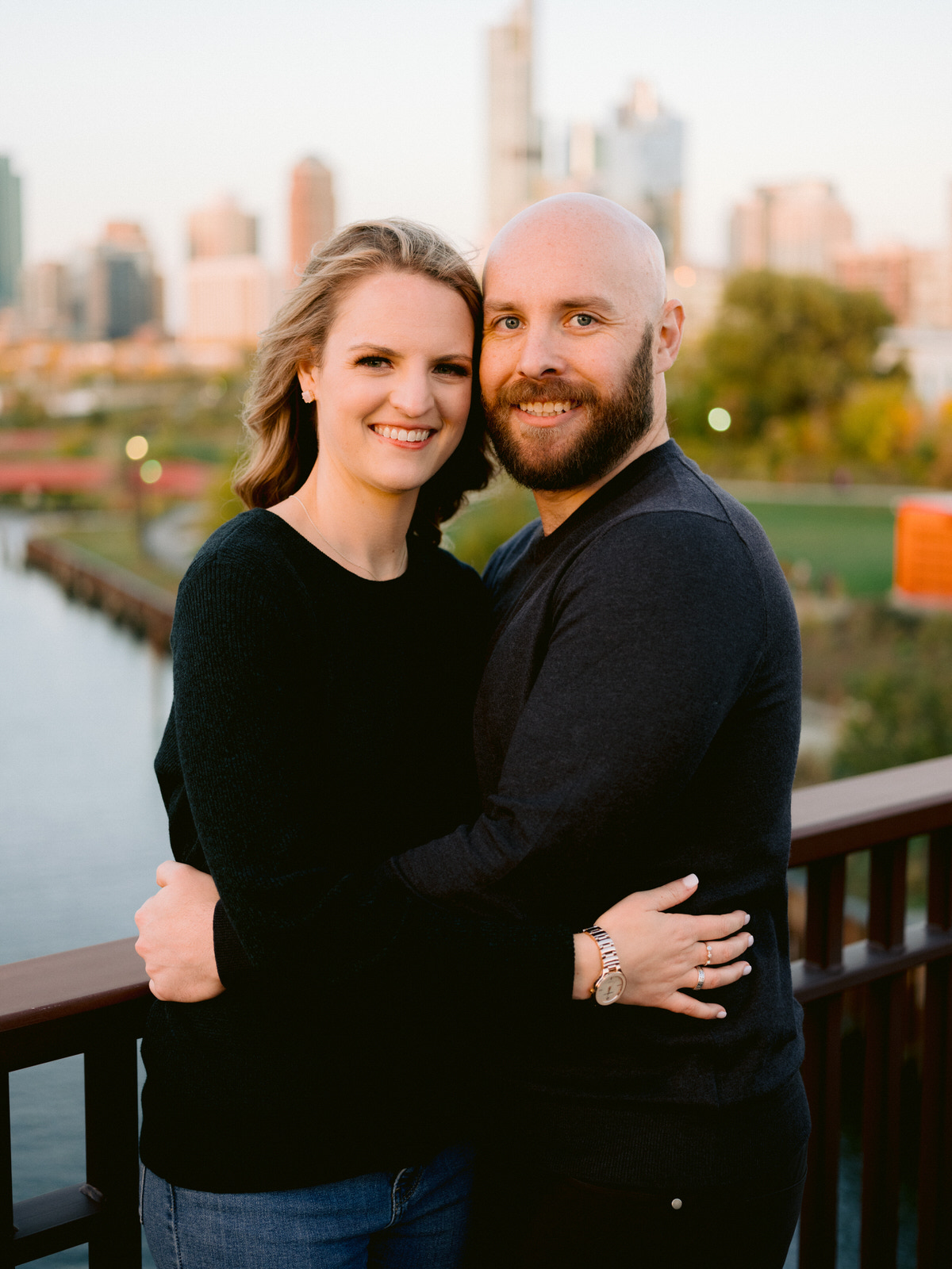 ping tom memorial park engagement photos couple smiling at camera with Chicago skyline in the background