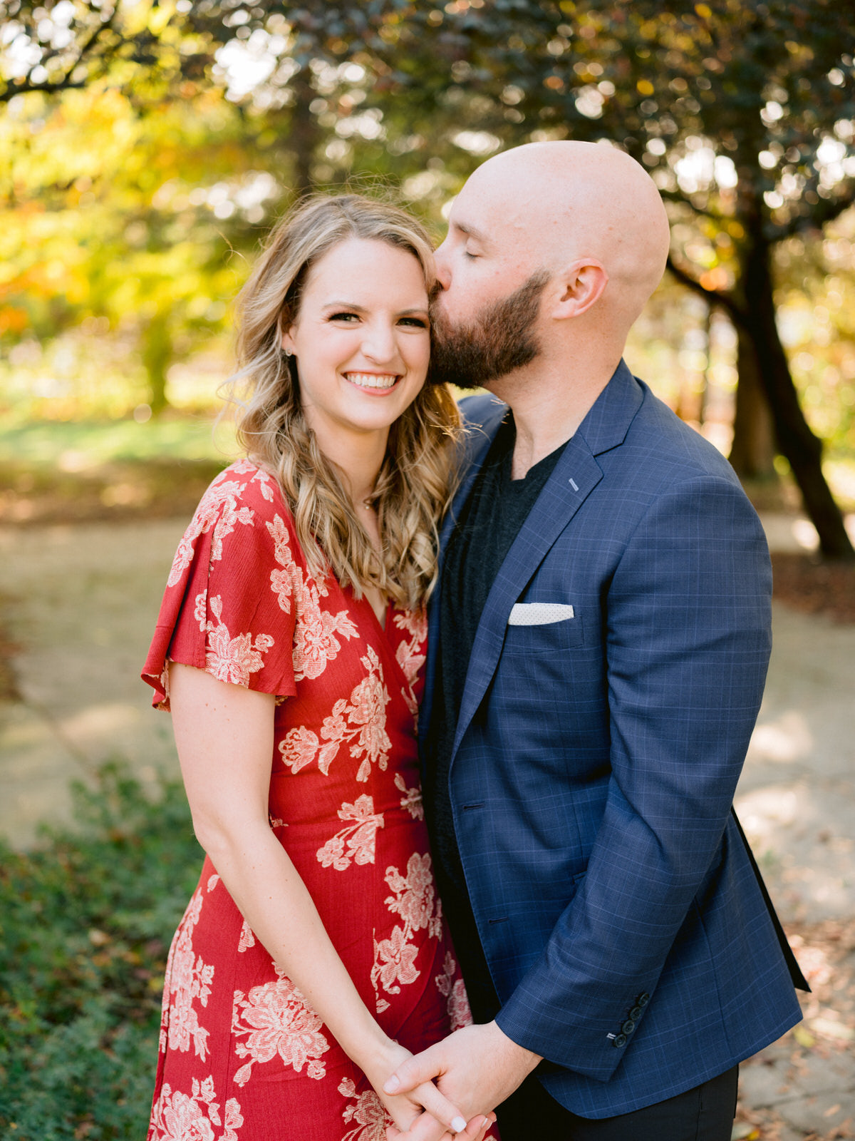 ping tom memorial park engagement photos girl smiling at camera and guy kissing her forehead