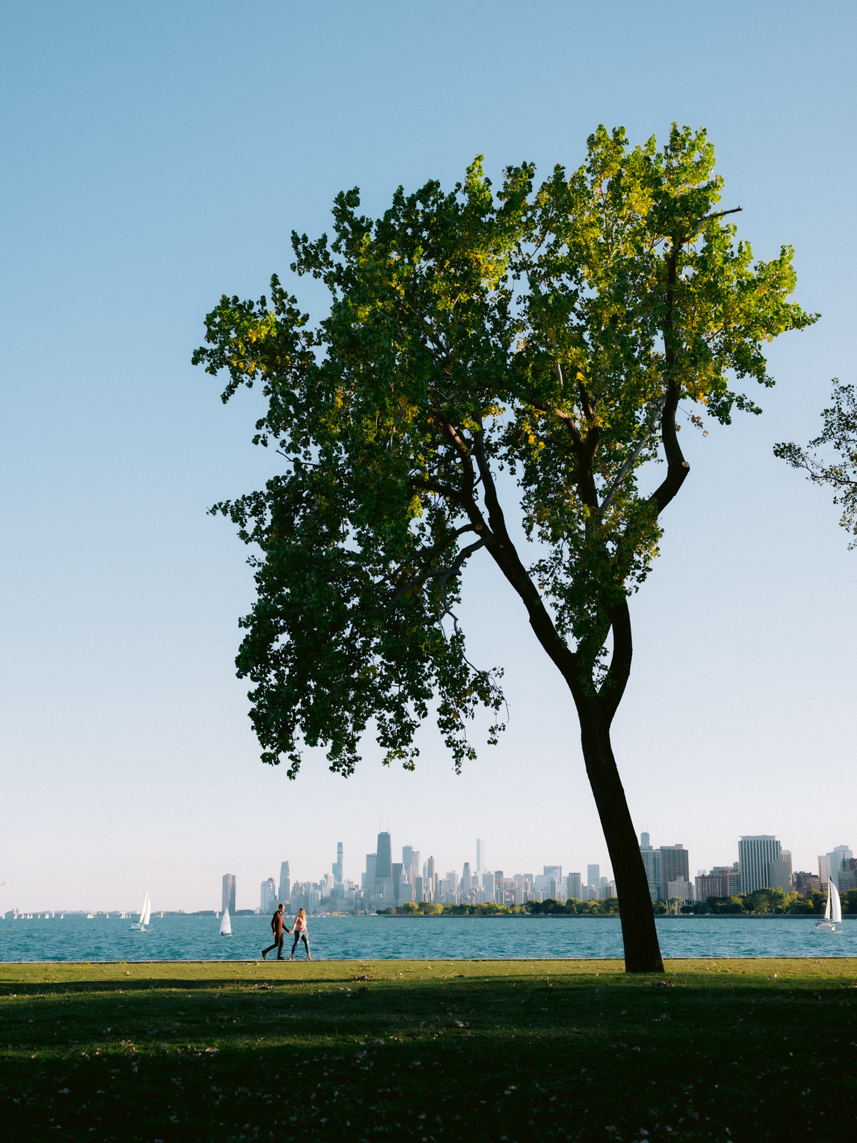 Chicago engagement session locations including the Chicago skyline at Montrose Harbor. Photos by wedding photographer Michael & Kristin Photo and Video.