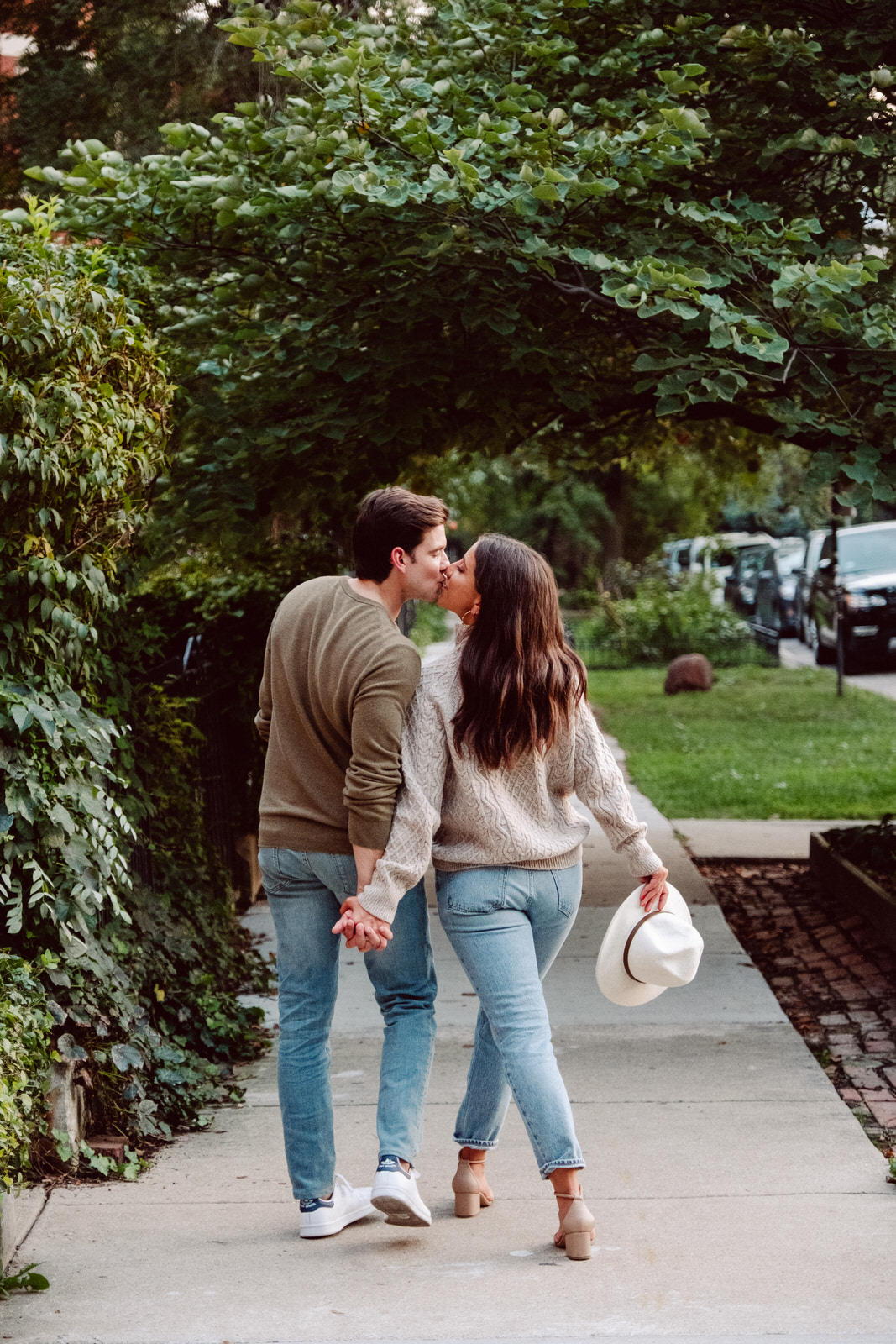 Couple walking down the street in Wicker Park for Chicago engagement session locations blog. Wedding photos by Michael & Kristin Photo and Video