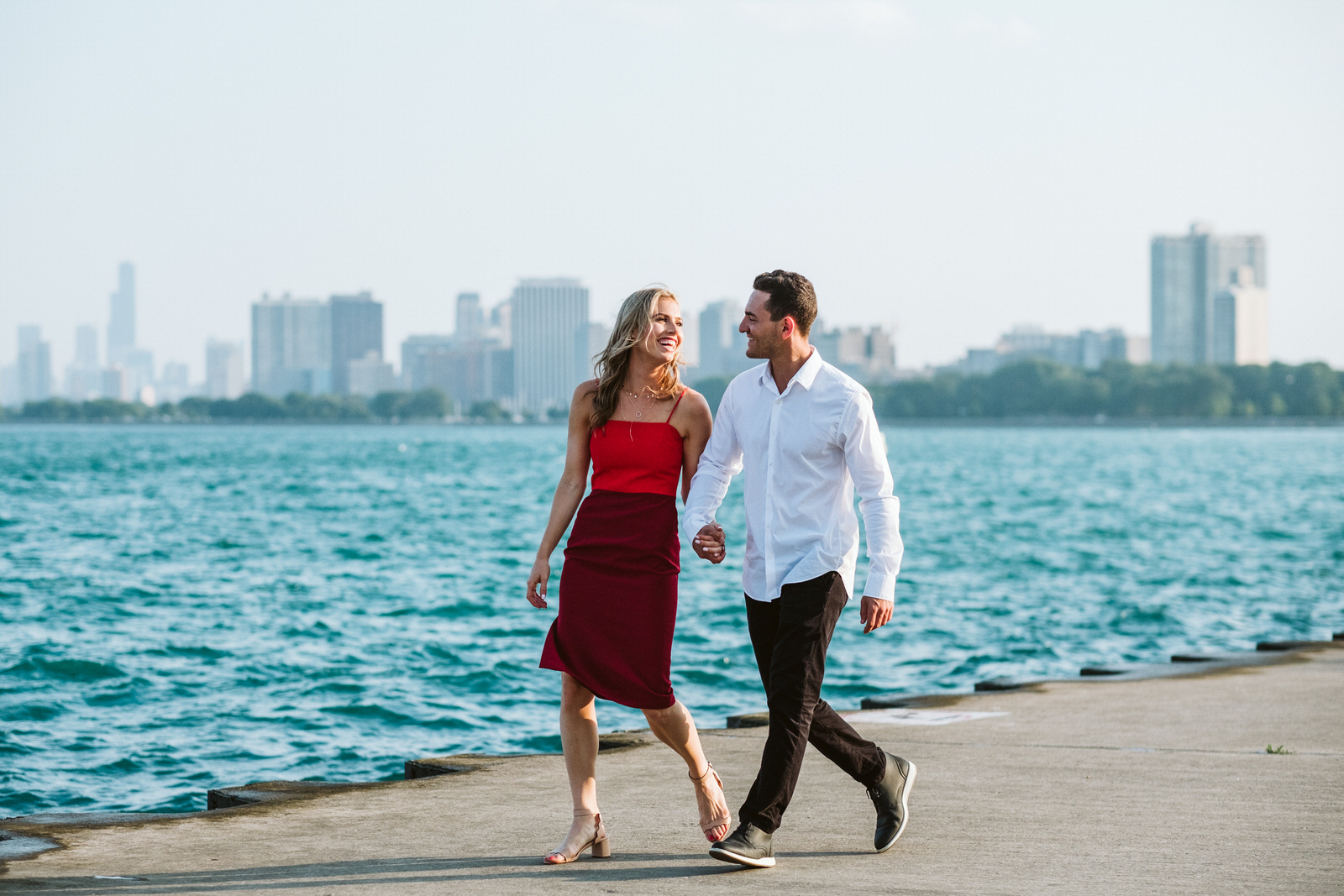 Chicago engagement session locations including the skyline at North Avenue Beach. Photos taken by luxury wedding photographer Michael & Kristin Photo and Video.